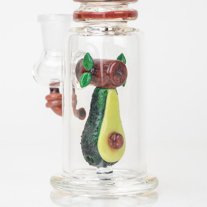 A close up of the glass avocado dab rig with upright mini tube body and side joint