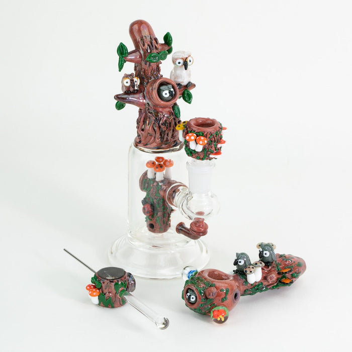 A collection forest themed glass ware including a forest mini rig, bowl piece, spoon pipe, and poker wand